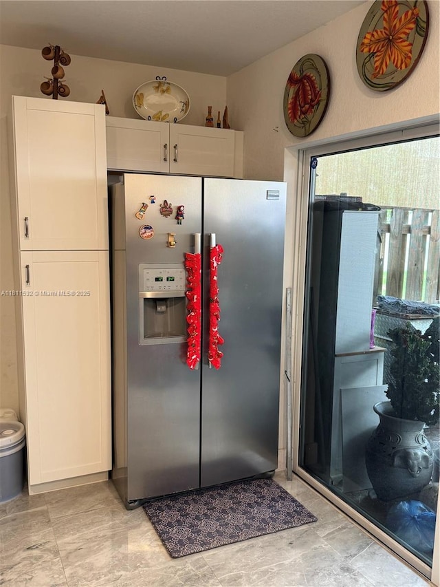 495 NE 5th Way, Florida City, FL 33034 - kitchen featuring stainless steel refrigerator with ice dispenser, plenty of natural light, and white cabinetry