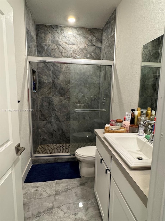 495 NE 5th Way, Florida City, FL 33034 - full bath featuring vanity, toilet, a shower stall, marble finish flooring, and a textured wall