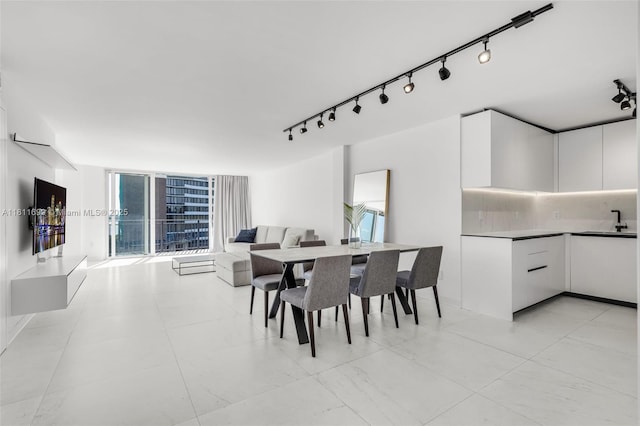 770 NE 69th St Unit 6C, Miami, FL 33138 - dining room with rail lighting and healthy amount of natural light