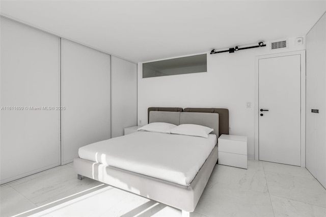 770 NE 69th St Unit 6C, Miami, FL 33138 - bedroom with light marble finish flooring and a closet
