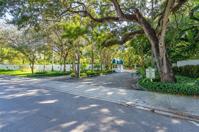 770 NE 69th St Unit 6C, Miami, FL 33138 - view of asphalt road featuring curbs, traffic signs, and view of scattered trees