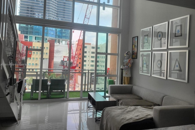244 Biscayne Blvd Unit 644, Miami, FL 33132 - living area featuring a view of city, tile patterned floors, and a high ceiling
