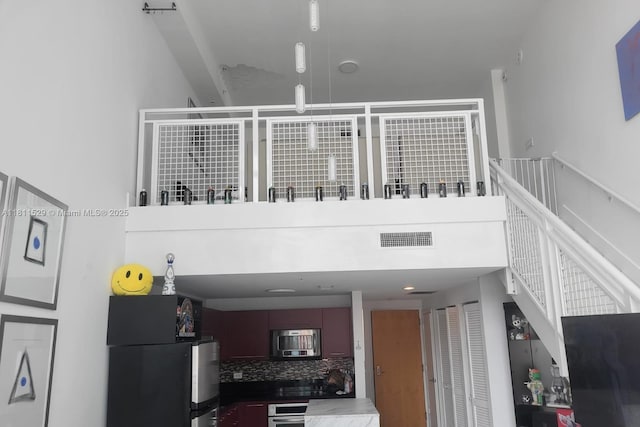 244 Biscayne Blvd Unit 644, Miami, FL 33132 - interior space with freestanding refrigerator, decorative backsplash, and stainless steel oven