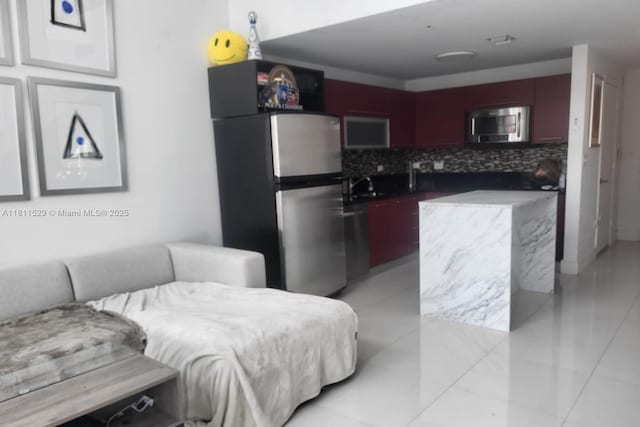 244 Biscayne Blvd Unit 644, Miami, FL 33132 - kitchen featuring stainless steel appliances, tasteful backsplash, a sink, and light tile patterned floors