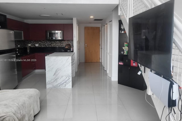 244 Biscayne Blvd Unit 644, Miami, FL 33132 - kitchen with stainless steel appliances, tasteful backsplash, dark brown cabinets, recessed lighting, and light tile patterned floors
