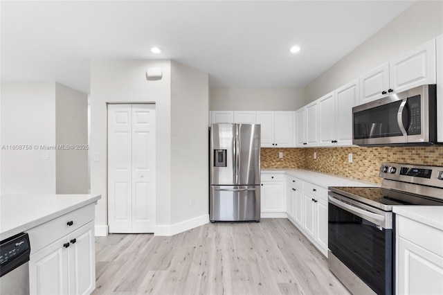 24083 SW 112th Pl, Homestead, FL 33032 - kitchen with appliances with stainless steel finishes, light wood-type flooring, backsplash, light countertops, and recessed lighting