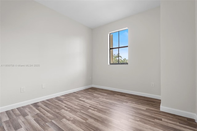 24083 SW 112th Pl, Homestead, FL 33032 - spare room featuring wood finished floors and baseboards