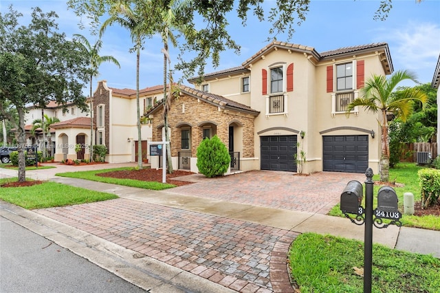 24083 SW 112th Pl, Homestead, FL 33032 - mediterranean / spanish-style home with stucco siding, an attached garage, decorative driveway, and a tile roof