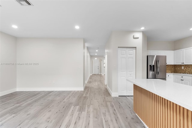 24083 SW 112th Pl, Homestead, FL 33032 - kitchen featuring stainless steel fridge, light wood-style floors, white cabinetry, recessed lighting, and light countertops