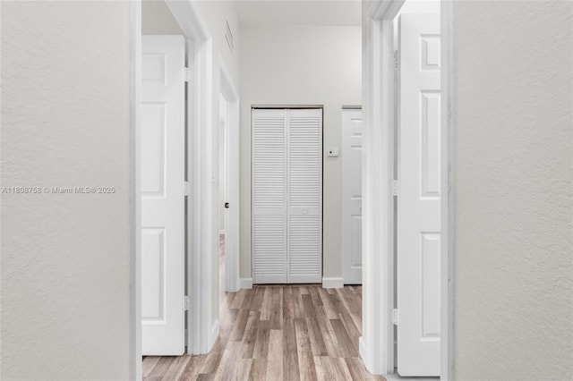 24083 SW 112th Pl, Homestead, FL 33032 - hallway featuring a textured wall and wood finished floors