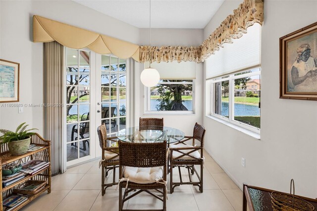 7059 Copperfield Cir, Lake Worth, FL 33467 - dining area with french doors, light tile patterned floors, and a water view