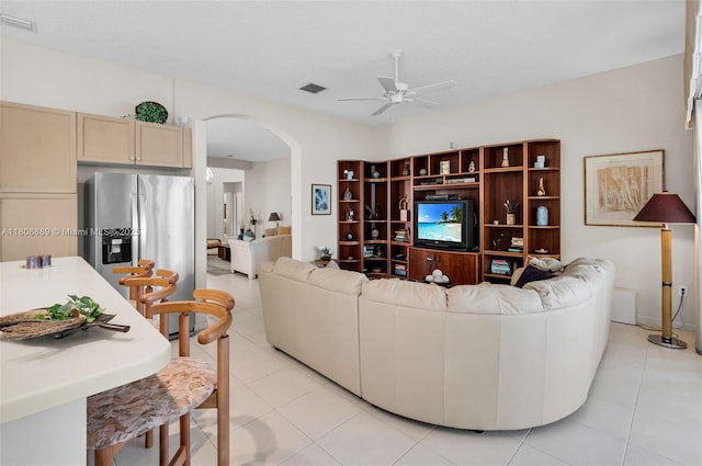 7059 Copperfield Cir, Lake Worth, FL 33467 - living room featuring arched walkways, a ceiling fan, and light tile patterned floors