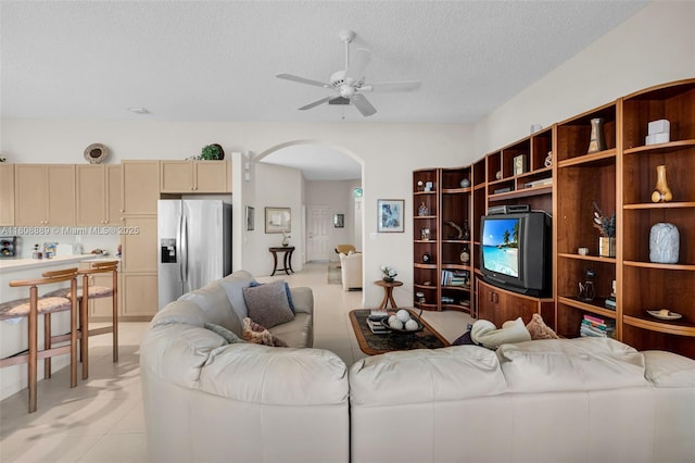 7059 Copperfield Cir, Lake Worth, FL 33467 - living area with ceiling fan, arched walkways, a textured ceiling, and light tile patterned flooring