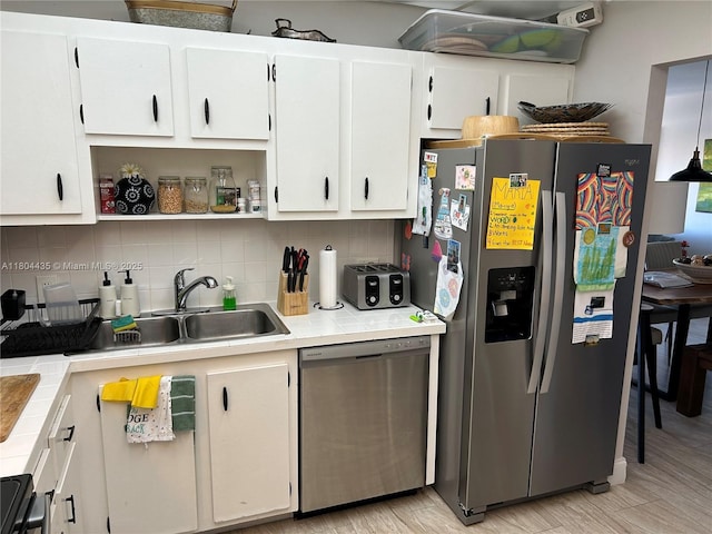 575 Crandon Blvd Unit 808, Key Biscayne, FL 33149 - kitchen with stainless steel appliances, tile counters, decorative backsplash, and white cabinetry