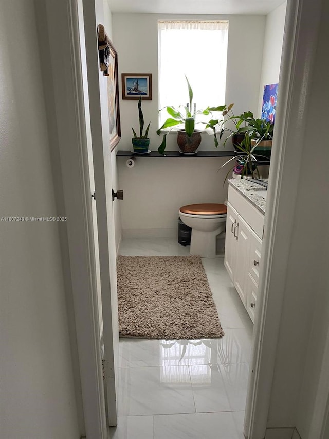 1811 Jefferson St Unit 607, Hollywood, FL 33020 - bathroom featuring vanity, toilet, and marble finish flooring