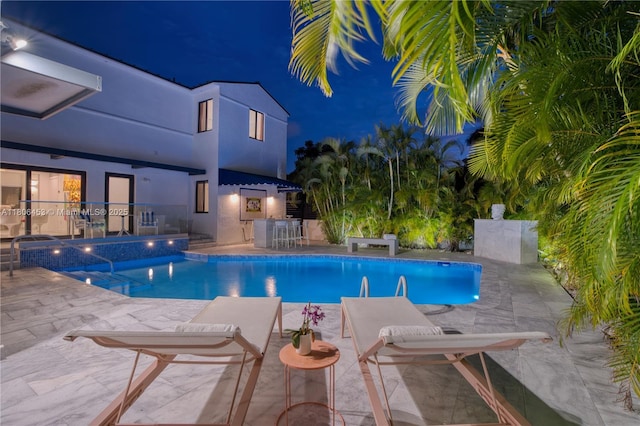 5970 Alton Rd, Miami Beach, FL 33140 - pool at night with an outdoor pool and a patio area