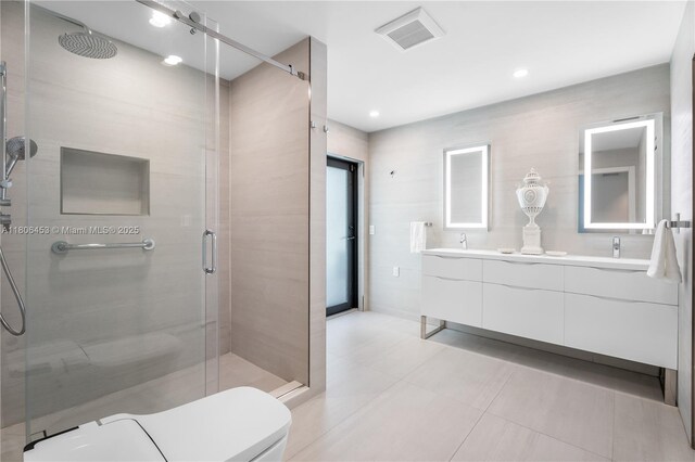 5970 Alton Rd, Miami Beach, FL 33140 - bathroom with double vanity, a shower stall, toilet, and tile patterned flooring