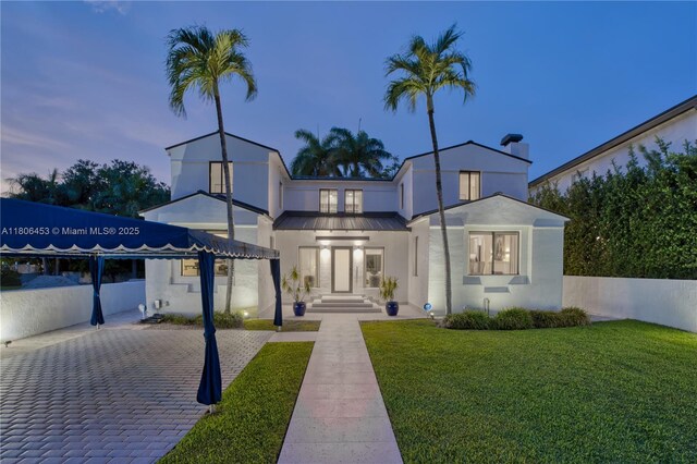 5970 Alton Rd, Miami Beach, FL 33140 - view of front of home featuring a front yard and stucco siding