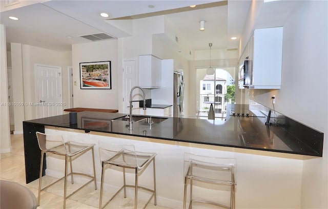 3900 Island Bl Ph 2, Aventura, FL 33160 - kitchen featuring a sink, white cabinetry, a peninsula, dark countertops, and recessed lighting