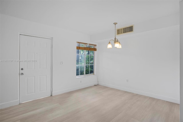 12154 Saint Andrews Pl Unit 112, Miramar, FL 33025 - spare room with light wood-style floors, a chandelier, and baseboards
