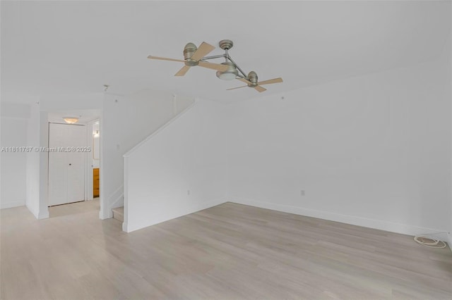 12154 Saint Andrews Pl Unit 112, Miramar, FL 33025 - empty room featuring light wood-style flooring, ceiling fan, stairs, and baseboards