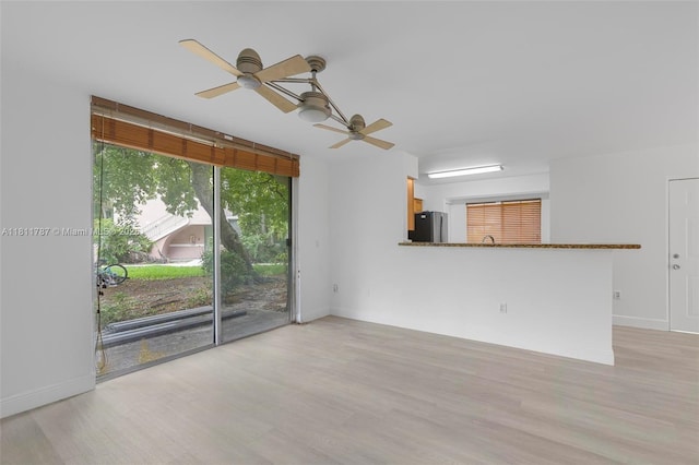 12154 Saint Andrews Pl Unit 112, Miramar, FL 33025 - unfurnished living room featuring ceiling fan, light wood-style floors, and baseboards