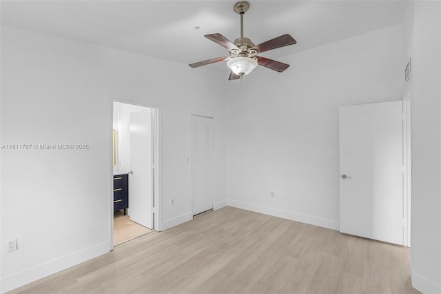 12154 Saint Andrews Pl Unit 112, Miramar, FL 33025 - unfurnished bedroom with light wood finished floors, baseboards, and ensuite bath