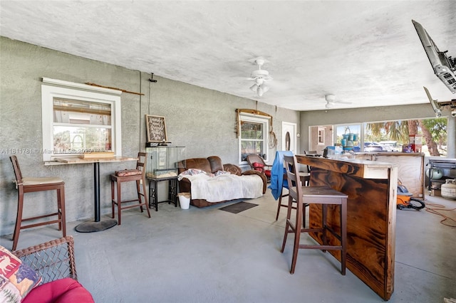 40691 Suzan Dr, Punta Gorda, FL 33982 - living area with ceiling fan, finished concrete floors, and a textured wall
