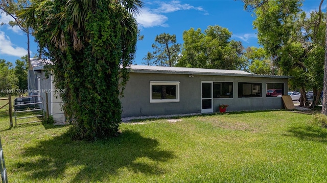 40691 Suzan Dr, Punta Gorda, FL 33982 - back of house with stucco siding and metal roof