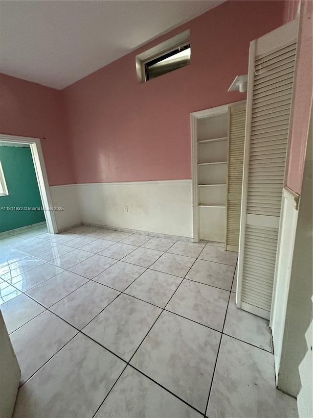 315 W 44th St, Hialeah, FL 33012 - spare room with a wainscoted wall and light tile patterned floors