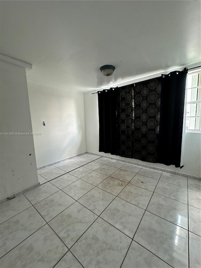 315 W 44th St, Hialeah, FL 33012 - spare room with light tile patterned flooring