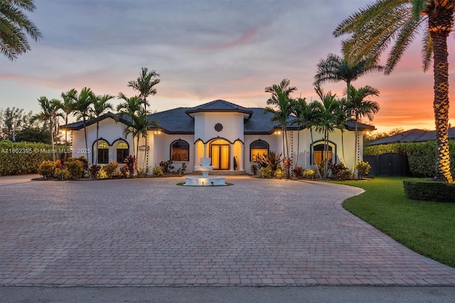 20120 SW 133rd Ave, Miami, FL 33177 - mediterranean / spanish-style home with curved driveway, stucco siding, and a front yard