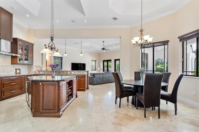 20120 SW 133rd Ave, Miami, FL 33177 - kitchen featuring a tray ceiling, a chandelier, hanging light fixtures, crown molding, and decorative backsplash