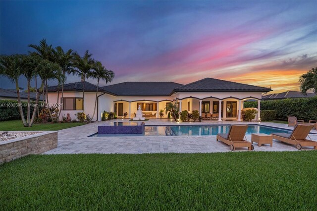 20120 SW 133rd Ave, Miami, FL 33177 - rear view of property with a yard, a patio area, and stucco siding