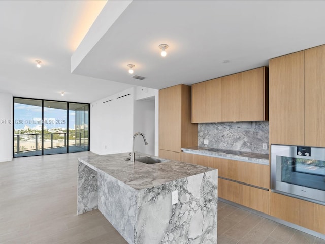 500 Alton Rd Unit 805, Miami Beach, FL 33139 - kitchen with a sink, stainless steel oven, floor to ceiling windows, modern cabinets, and black electric cooktop