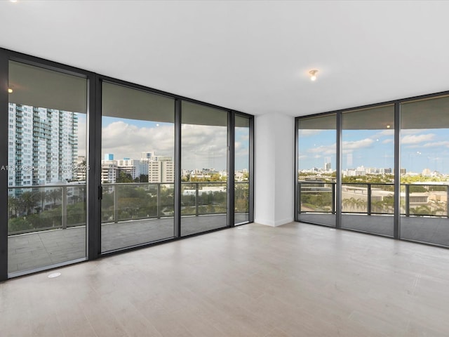 500 Alton Rd Unit 805, Miami Beach, FL 33139 - empty room with floor to ceiling windows, a view of city, and wood finished floors