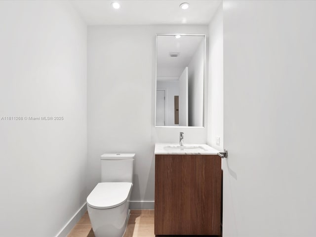500 Alton Rd Unit 805, Miami Beach, FL 33139 - bathroom featuring toilet, vanity, baseboards, and recessed lighting