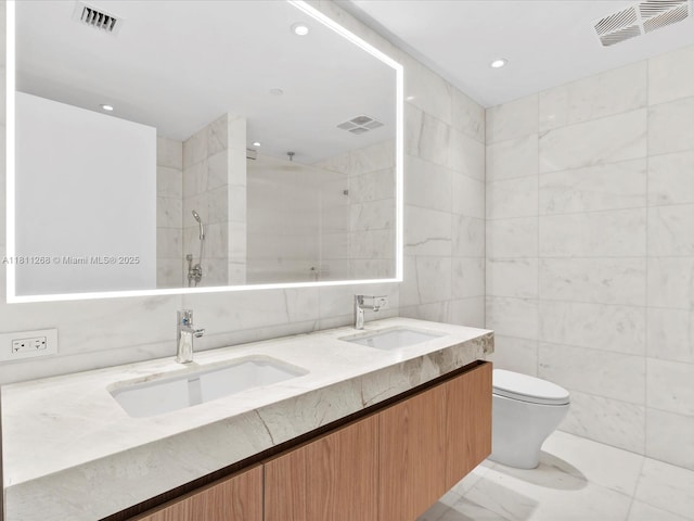 500 Alton Rd Unit 805, Miami Beach, FL 33139 - full bathroom featuring tile walls, toilet, double vanity, a tile shower, and recessed lighting