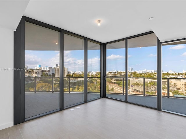 500 Alton Rd Unit 805, Miami Beach, FL 33139 - empty room featuring expansive windows, a city view, and wood finished floors