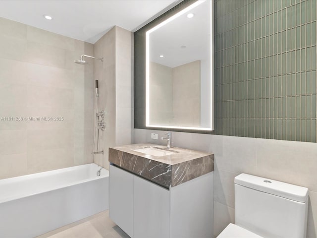 500 Alton Rd Unit 805, Miami Beach, FL 33139 - bathroom featuring tile walls, vanity, toilet, bathing tub / shower combination, and recessed lighting