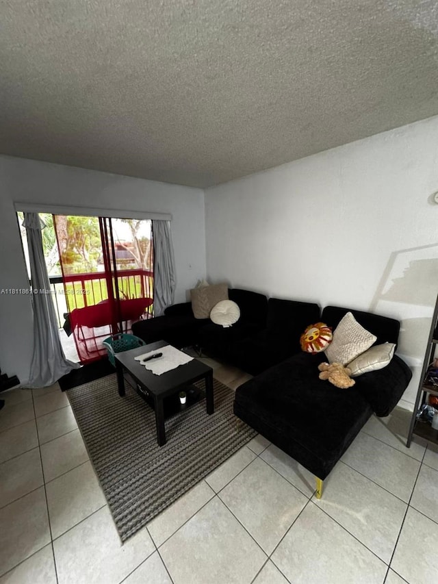 6023 10th Ave N Unit 215, Green Acres, FL 33463 - living area featuring a textured ceiling and light tile patterned floors