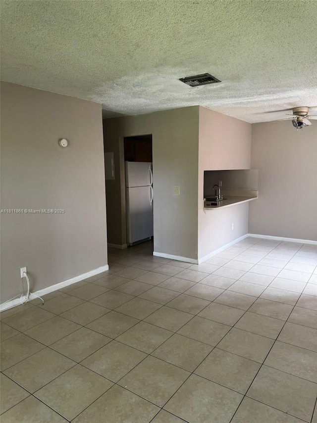 6023 10th Ave N Unit 215, Green Acres, FL 33463 - tiled spare room featuring a textured ceiling and baseboards