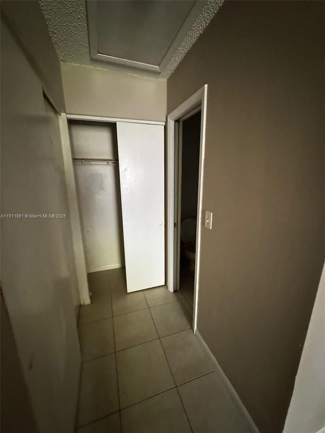 6023 10th Ave N Unit 215, Green Acres, FL 33463 - unfurnished bedroom with tile patterned floors and a closet