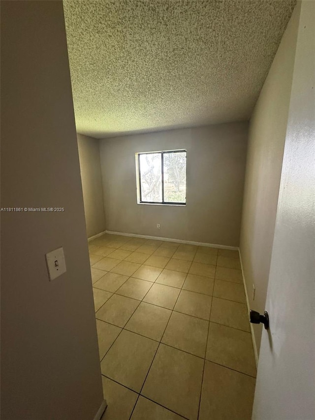 6023 10th Ave N Unit 215, Green Acres, FL 33463 - unfurnished room with light tile patterned flooring and a textured ceiling