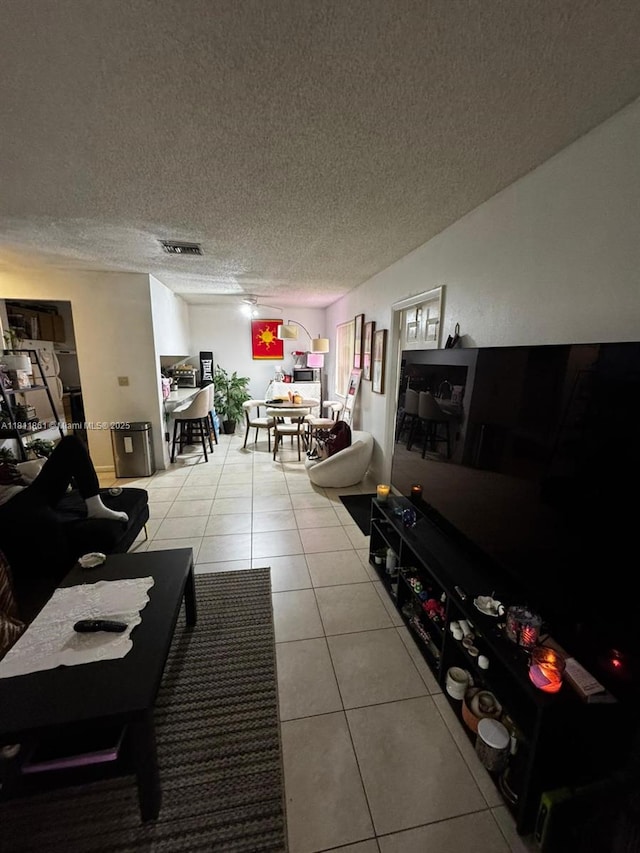 6023 10th Ave N Unit 215, Green Acres, FL 33463 - living area featuring tile patterned floors and a textured ceiling