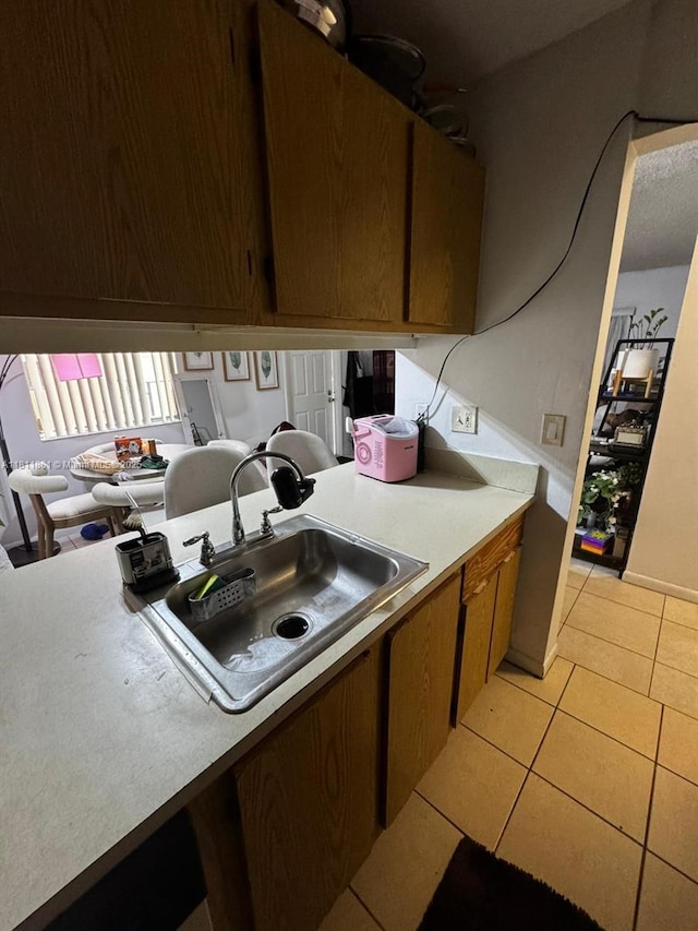 6023 10th Ave N Unit 215, Green Acres, FL 33463 - kitchen featuring a sink, light countertops, and light tile patterned floors