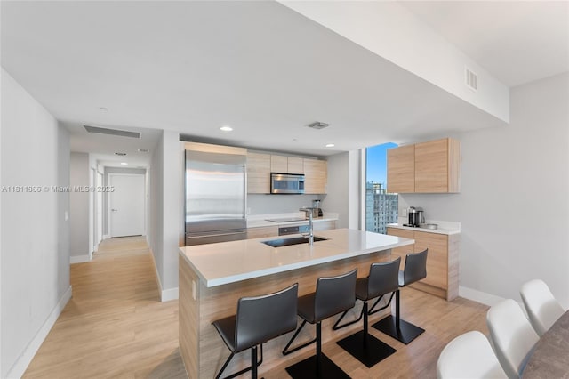 16385 NE Biscayne Blvd Unit 1901Storage, North Miami Beach, FL 33160 - kitchen with appliances with stainless steel finishes, modern cabinets, light brown cabinetry, and a sink