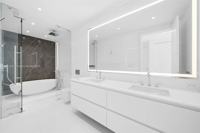 300 Biscayne Blvd Way Unit 3606, Miami, FL 33130 - bathroom featuring double vanity, a freestanding tub, recessed lighting, toilet, and marble finish floors
