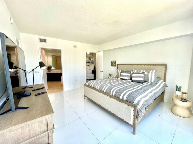 250 Sunny Isles Blvd Unit 3-602, Sunny Isles Beach, FL 33160 - bedroom with light tile patterned floors and a textured ceiling