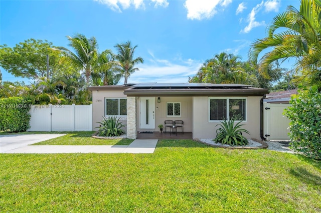 17491 NE 19th Ave, North Miami Beach, FL 33162 - mid-century modern home with a gate, stucco siding, and roof mounted solar panels